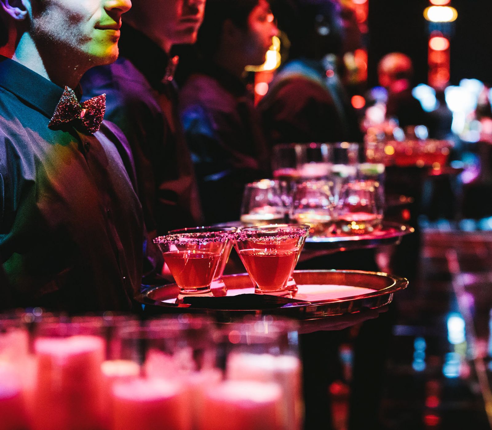 Servers with trays of drinks.
